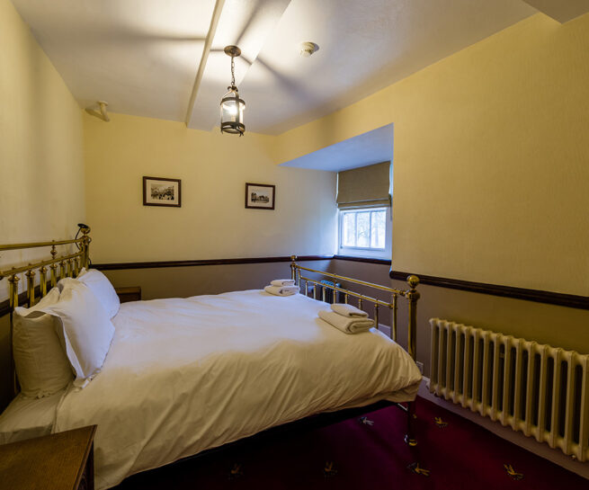 Large brass bed in the Le Meshin bedroom at Appleby Castle in Cumbria