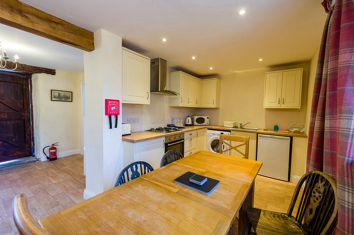 Dining table and kitchen in the self-contained holiday cottages at Appleby Castle